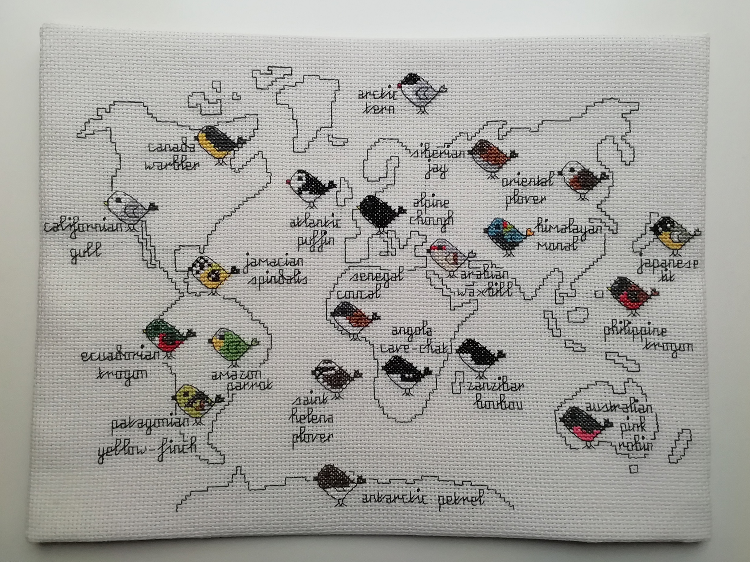 cross stitch of a map with birds